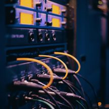 pexels-photo-1054397-1054397-1 Close-up of network cables and ports in a server rack, showcasing connectivity.